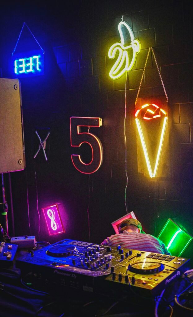 DJ booth with neon lighting and professional event equipment