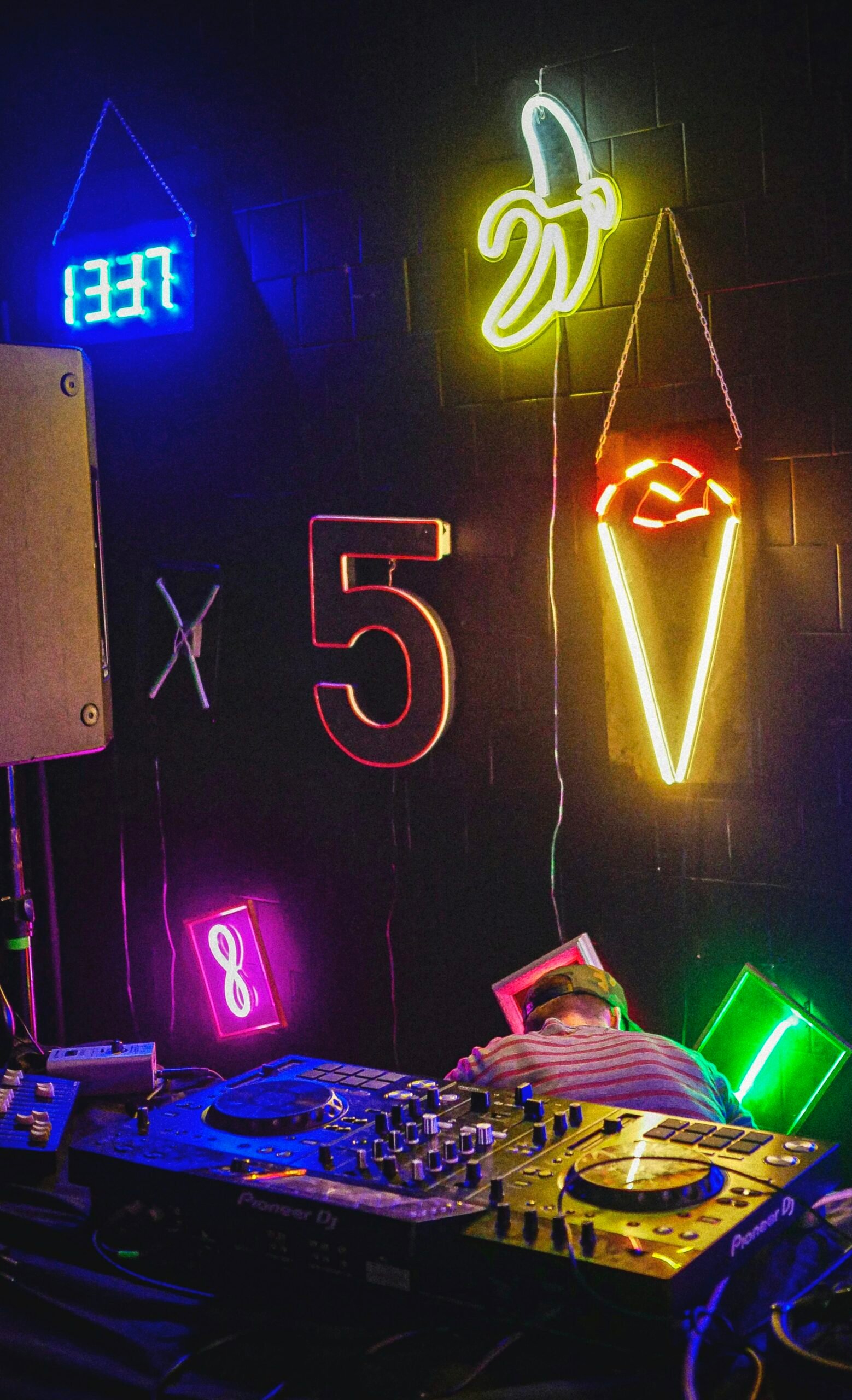 DJ booth with neon lighting and professional event equipment